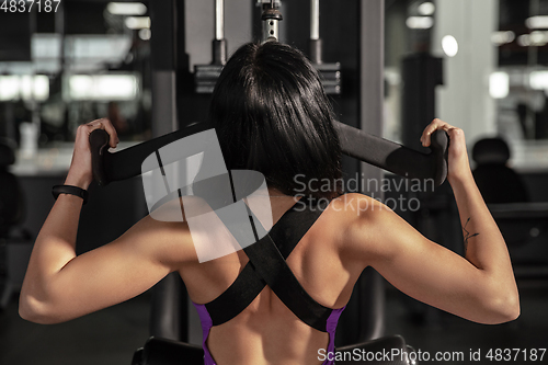 Image of The female athlete training hard in the gym. Fitness and healthy life concept.