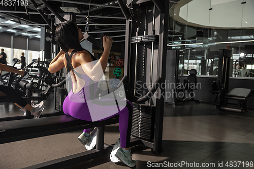 Image of The female athlete training hard in the gym. Fitness and healthy life concept.