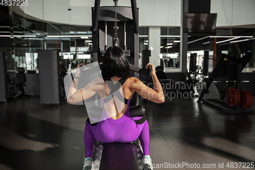 Image of The female athlete training hard in the gym. Fitness and healthy life concept.