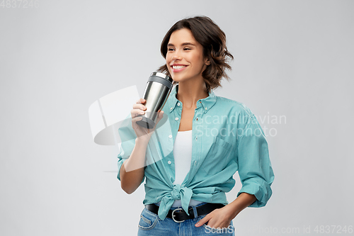 Image of woman with thermo cup or tumbler for hot drinks