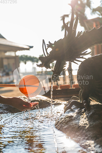 Image of Bamboo fountain and dragon under sunlight