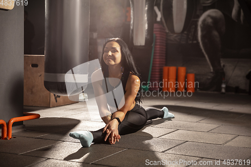 Image of The female athlete training hard in the gym. Fitness and healthy life concept.