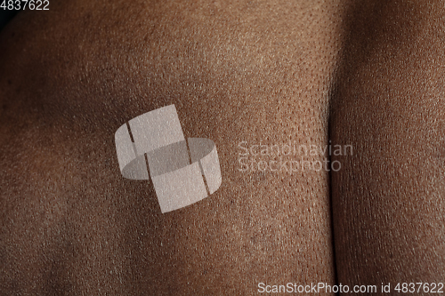 Image of Texture of human skin. Close up of african-american male body