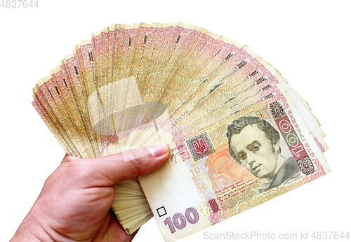 Image of Ukrainian money of value 100 in the hand isolated
