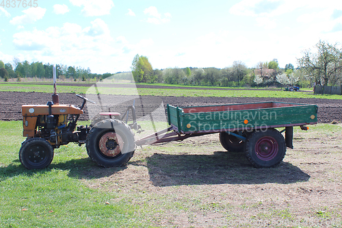 Image of tractor with trailer in the village