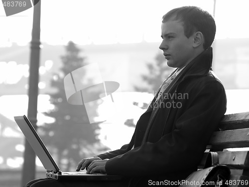 Image of Young businesman with laptop