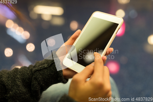 Image of Woman holding cellphone