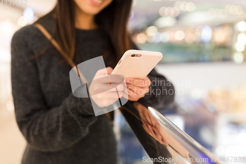 Image of Woman working on mobile phone