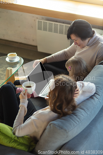 Image of Happy loving family. Grandmother, mother and daughter spending time together