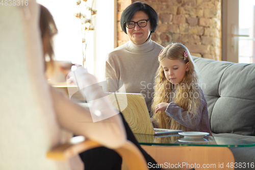 Image of Happy loving family. Grandmother, mother and daughter spending time together