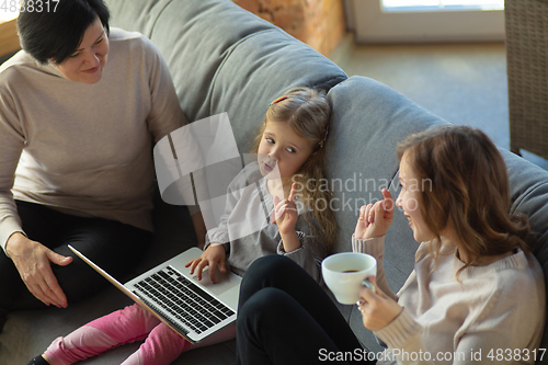 Image of Happy loving family. Grandmother, mother and daughter spending time together