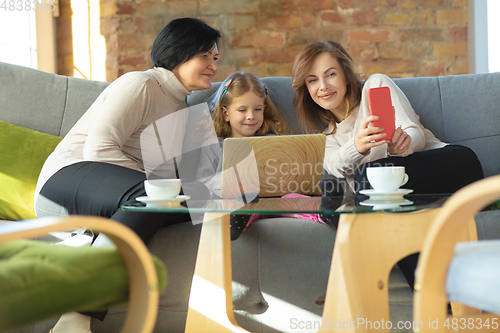 Image of Happy loving family. Grandmother, mother and daughter spending time together