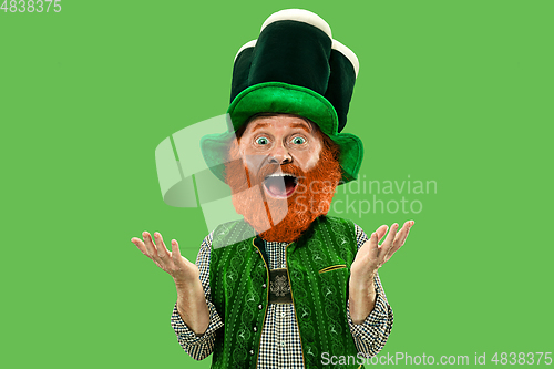 Image of Excited leprechaun in green suit with red beard on white background