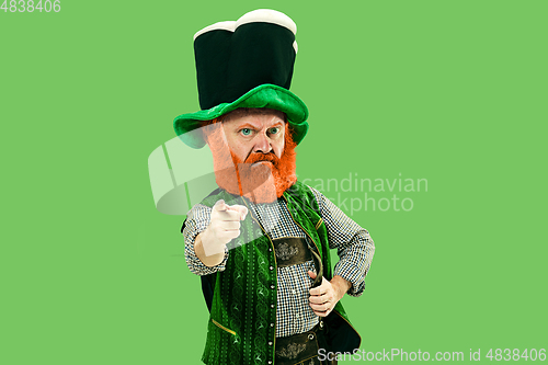 Image of Excited leprechaun in green suit with red beard on white background