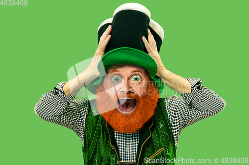 Image of Excited leprechaun in green suit with red beard on white background