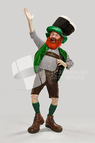 Image of Excited leprechaun in green suit with red beard on white background