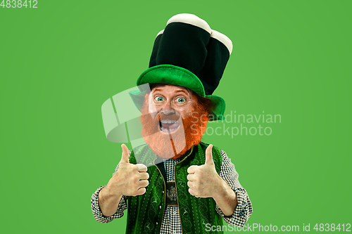 Image of Excited leprechaun in green suit with red beard on white background