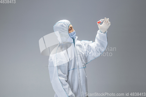 Image of Medic in white hazmat protective suit, coronavirus illustration concept