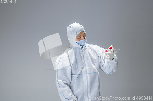 Image of Medic in white hazmat protective suit, coronavirus illustration concept