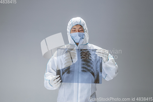 Image of Medic in white hazmat protective suit, coronavirus illustration concept