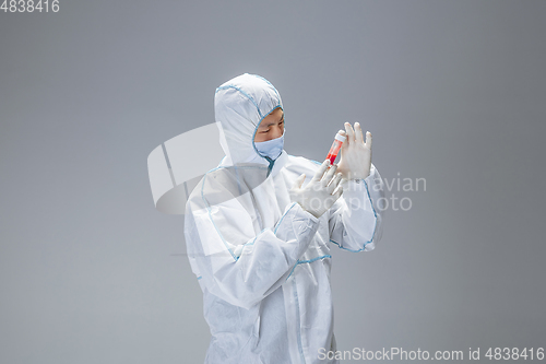 Image of Medic in white hazmat protective suit, coronavirus illustration concept