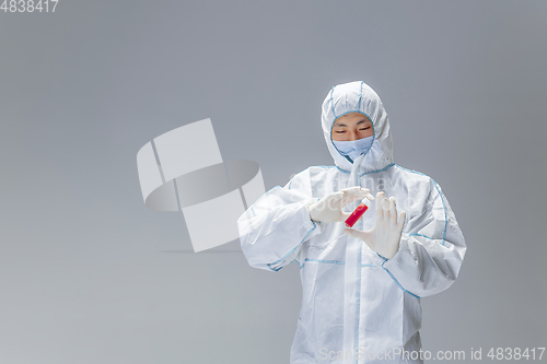 Image of Medic in white hazmat protective suit, coronavirus illustration concept