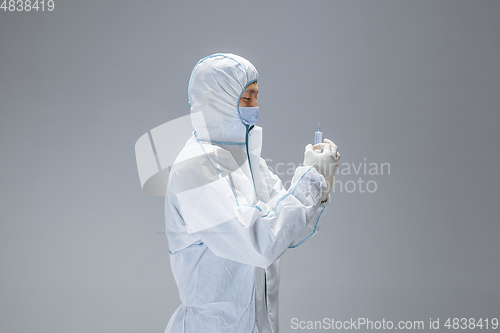 Image of Medic in white hazmat protective suit, coronavirus illustration concept