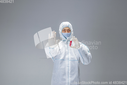 Image of Medic in white hazmat protective suit, coronavirus illustration concept