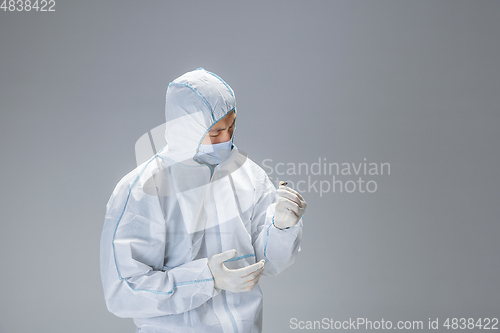 Image of Medic in white hazmat protective suit, coronavirus illustration concept