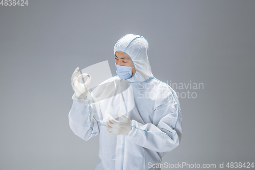 Image of Medic in white hazmat protective suit, coronavirus illustration concept