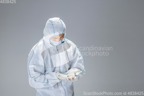 Image of Medic in white hazmat protective suit, coronavirus illustration concept