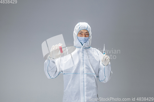 Image of Medic in white hazmat protective suit, coronavirus illustration concept