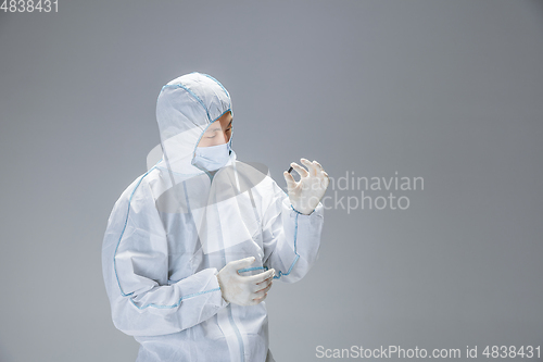 Image of Medic in white hazmat protective suit, coronavirus illustration concept