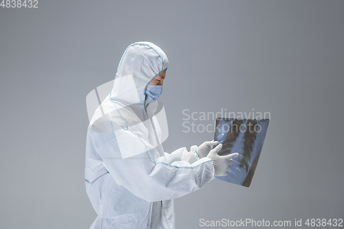 Image of Medic in white hazmat protective suit, coronavirus illustration concept