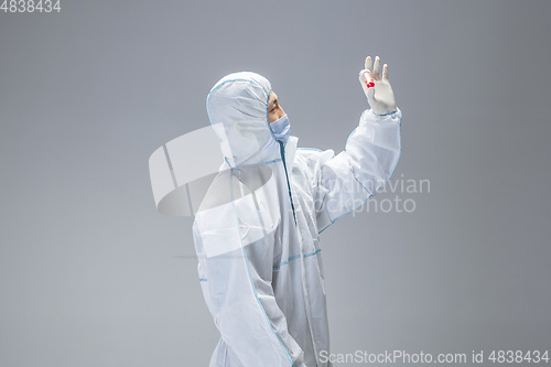 Image of Medic in white hazmat protective suit, coronavirus illustration concept