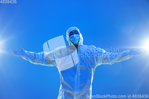 Image of Medic in white hazmat protective suit, coronavirus illustration concept