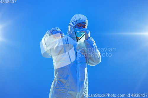 Image of Medic in white hazmat protective suit, coronavirus illustration concept