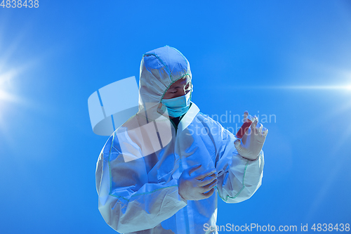 Image of Medic in white hazmat protective suit, coronavirus illustration concept