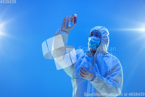 Image of Medic in white hazmat protective suit, coronavirus illustration concept