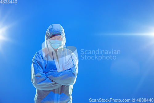 Image of Medic in white hazmat protective suit, coronavirus illustration concept