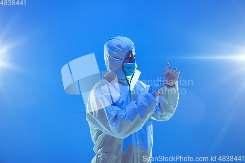 Image of Medic in white hazmat protective suit, coronavirus illustration concept