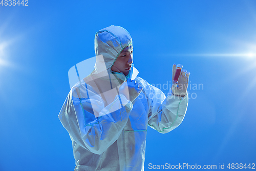 Image of Medic in white hazmat protective suit, coronavirus illustration concept