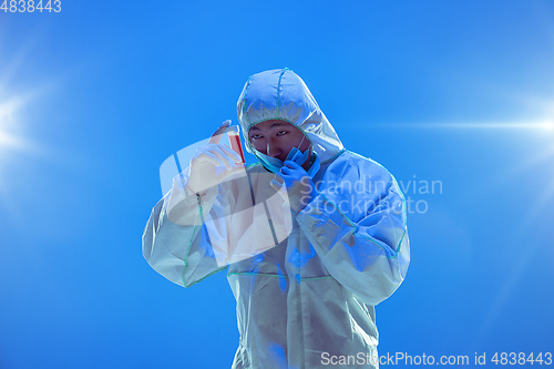 Image of Medic in white hazmat protective suit, coronavirus illustration concept