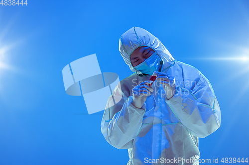 Image of Medic in white hazmat protective suit, coronavirus illustration concept