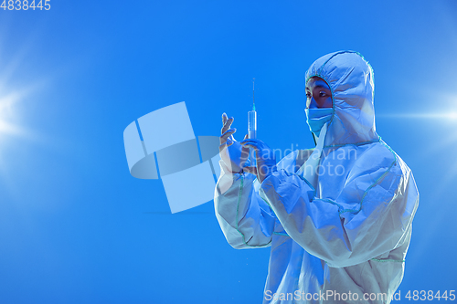 Image of Medic in white hazmat protective suit, coronavirus illustration concept