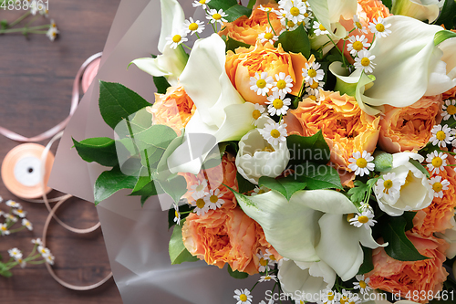 Image of Close up of fashion modern bouquet of different flowers on wooden background