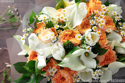 Image of Close up of fashion modern bouquet of different flowers on wooden background
