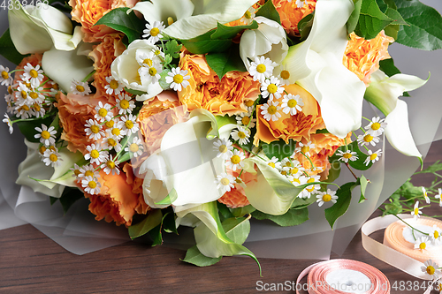 Image of Close up of fashion modern bouquet of different flowers on wooden background