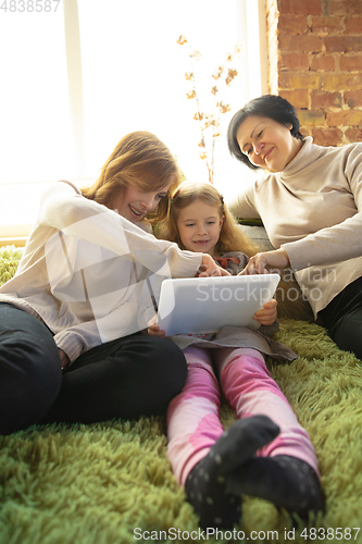 Image of Happy loving family. Grandmother, mother and daughter spending time together