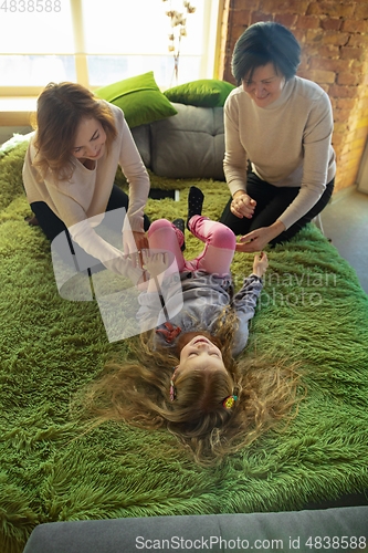 Image of Happy loving family. Grandmother, mother and daughter spending time together